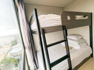 a bunk bed in a room with a window at Lovina 7-AA at One Residence in Batam Center +21 photos