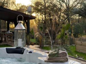 a bathroom sink with a lantern in a backyard at Le Chalet du lac in Biscarrosse