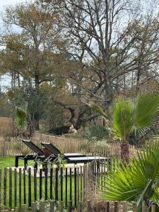 a park with two picnic tables and a fence at Le Chalet du lac in Biscarrosse +73 photos