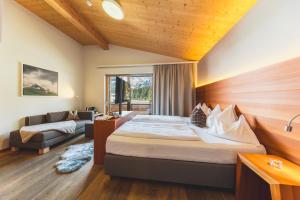 a hotel room with a bed and a couch at Mats Lech Alpenquartier in Lech am Arlberg +76 photos