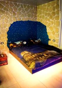 a bed in a room with a stone wall at Fantasy House in Cremona