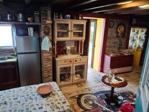 a kitchen with a stove and a refrigerator at Casa d'Alegria Madeira Island in Ribeira Brava