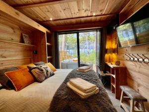a bedroom with a large bed and a window at Le Chalet Maguide in Biscarrosse