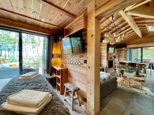 a bedroom with a bed and a couch in a room at Le Chalet Maguide in Biscarrosse +51 photos