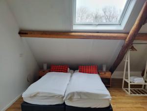 a bedroom with two beds in front of a window at Studio@Domburg in Domburg