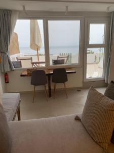 a living room with a desk and a view of the ocean at HADARIK by the sea in Benitses