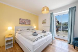 a bedroom with a bed and a large window at Alpine Zeitgeist Apartment - by myNests in Gröbming
