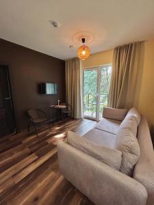 a living room with a couch and a table at 4 winds Notus in Palanga