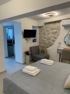 a room with a bed with two towels on it at HADARIK by the sea in Benitses