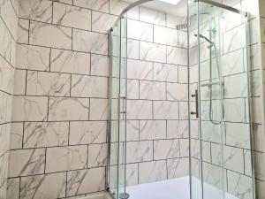 a bathroom with a shower with a glass door at The Granby Rooms Easington East Yorkshire in Easington