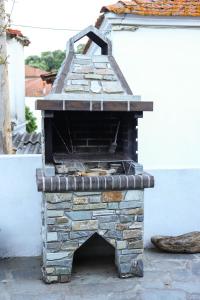 an outdoor brick oven sitting on a patio at House Marika - between Sea & mountains in Sykia Chalkidikis