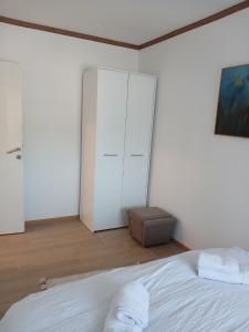 a bedroom with a white bed and a closet at APARTMAN Verica 2025 in Vrdnik +2 photos