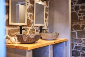 two sinks on a wooden counter in a bathroom at House Marika - between Sea & mountains in Sykia Chalkidikis