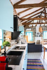 a kitchen with a sink and a counter top at House Marika - between Sea & mountains in Sykia Chalkidikis
