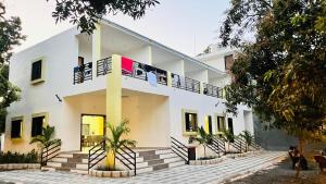 a building with a balcony with people sitting on it at Chandan resort in Chitrāwal
