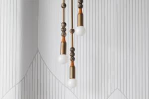 a cluster of lights hanging from a wall at Kimpton KAFD Riyadh by IHG in Riyadh