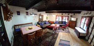 a living room with a couch and a table at Chalupka pod Kozincom - Zázrivá in Zázrivá +14 photos