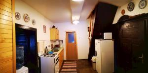 a kitchen with a white refrigerator and a stove at Chalupka pod Kozincom - Zázrivá in Zázrivá