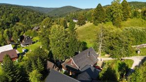 an aerial view of a house in a forest at Chalupka pod Kozincom - Zázrivá in Zázrivá