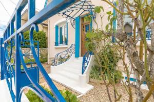 a house with blue doors and stairs in front at La Montrachet in Dijon