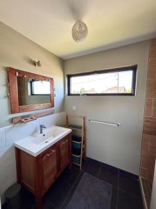 a bathroom with a sink and a mirror at Le kesson in Saint-Brieuc