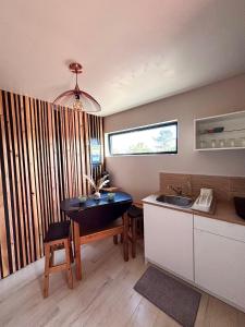 a kitchen with a table and a sink and a counter at Le kesson in Saint-Brieuc