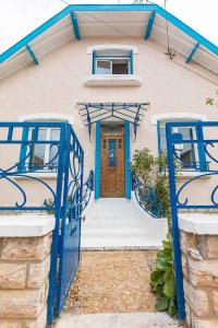 a house with blue doors in front of it at La Montrachet in Dijon
