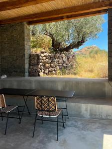 a table and two chairs in front of a window at ARETI Horizon in Kástron