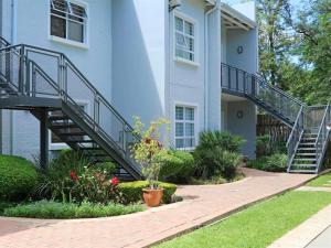 a house with a staircase in front of it at Apartments @ 125 in Gaborone