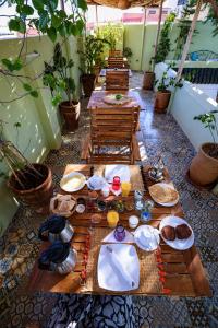 a long wooden table with plates of food on it at Riad O LY in Marrakesh