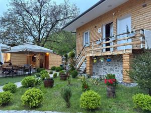 a house with a garden in front of it at Samuel's Rooms in Theth