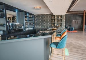 a bar with a blue chair at a counter at Steinberger Hof in Dietzenbach