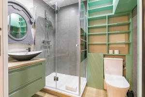 a bathroom with a shower and a toilet and a sink at Le Cote D'Or in Dijon