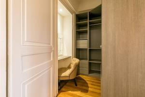 a room with a chair and a closet at Le Cote D'Or in Dijon +7 photos