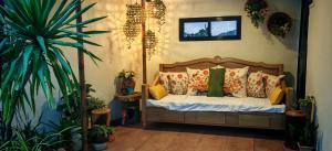 a bedroom with a bed with pillows and plants at GRG Stays-MatteoS in Santo Domingo