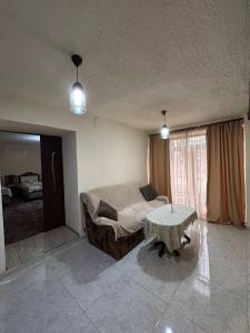 a bedroom with a bed and a table in it at Lucy Apartment Goris in Goris