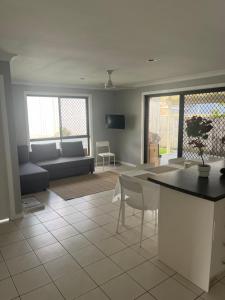 a living room with a couch and a table at Coomera Private Rooms near DreamWorld in Gold Coast
