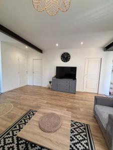 a living room with a couch and a flat screen tv at Bosquet in Valence