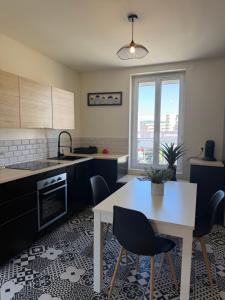 a kitchen with a table and chairs and a window at Bosquet in Valence