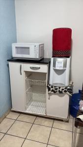 a kitchen with two microwaves and a microwave on a counter at Ap Praia das Pitangueiras in Guarujá