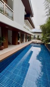 a swimming pool in front of a house at Choox Villa Hotel in Koronadal