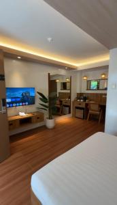 a room with a bed and a kitchen and a living room at Choox Villa Hotel in Koronadal
