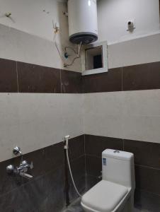 a bathroom with a toilet and a sink at Mahadev grand in Tirupati +5 photos