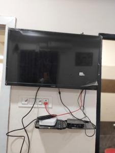 a flat screen tv hanging on a wall at Mahadev grand in Tirupati