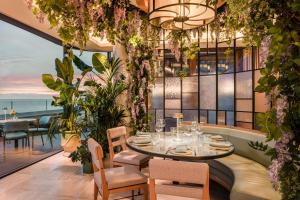 a restaurant with a table and chairs and a view of the ocean at Anantara Plaza Nice Hotel - A Leading Hotel of the World in Nice