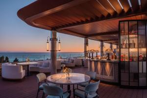 a restaurant with a view of the ocean at Anantara Plaza Nice Hotel - A Leading Hotel of the World in Nice +61 photos