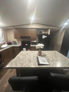 a kitchen with a table with a vase of flowers on it at The Relaxation Haven 