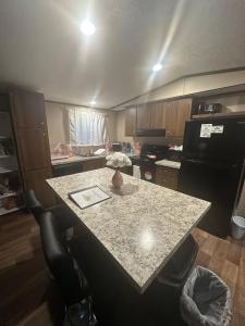 a kitchen with a table and a counter top at The Relaxation Haven 