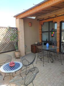 a patio with chairs and a table and a table and chairs at Riad Medina Taroudant in Taroudant