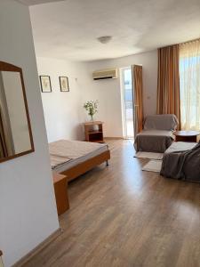 a hotel room with two beds and a mirror at Hotel Andre in Burgas
